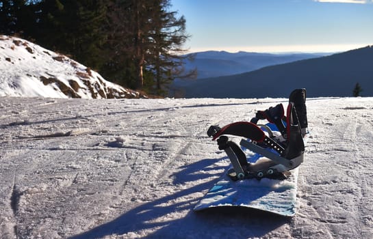 Winter sports. Snowboard on snow ski slope.   