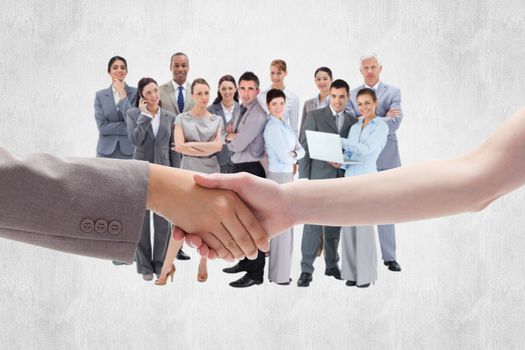 Handshake between two women against white background