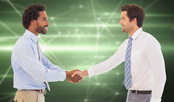 Smiling young businessmen shaking hands in office against glowing geometric design