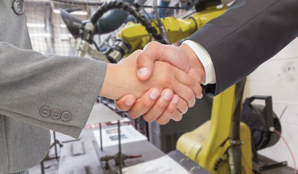 Handshake between two business people against garage
