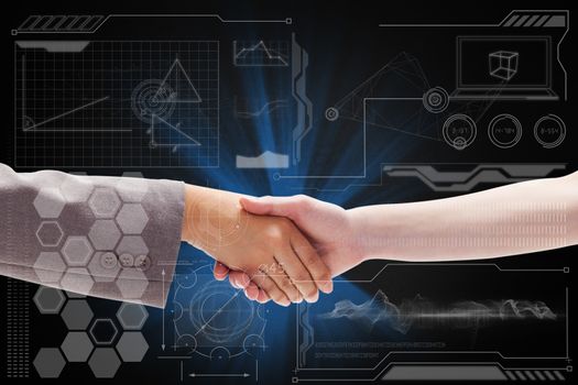Handshake between two women against technology interface