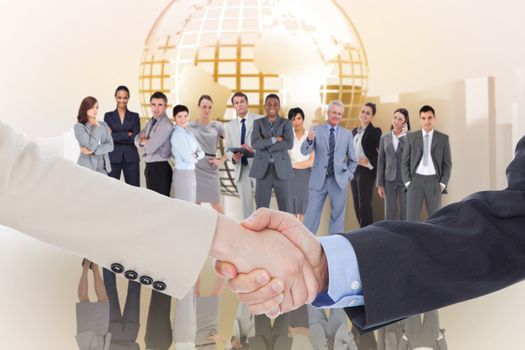 Smiling business people shaking hands while looking at the camera against planet on abstract background