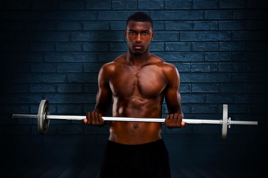 Fit man lifting barbell against black background