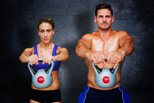 Bodybuilding couple against black background