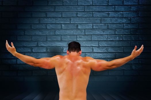 Bodybuilder posing against black background
