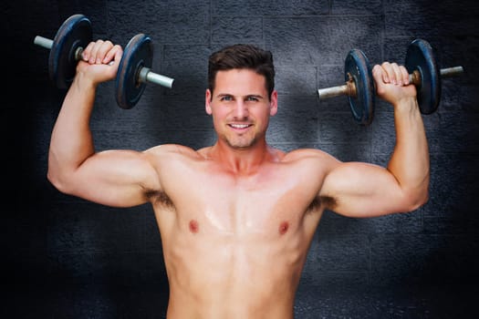 Bodybuilder lifting dumbbells against black background