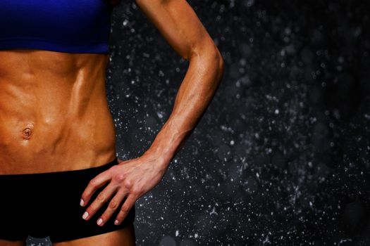 Female bodybuilder against black background