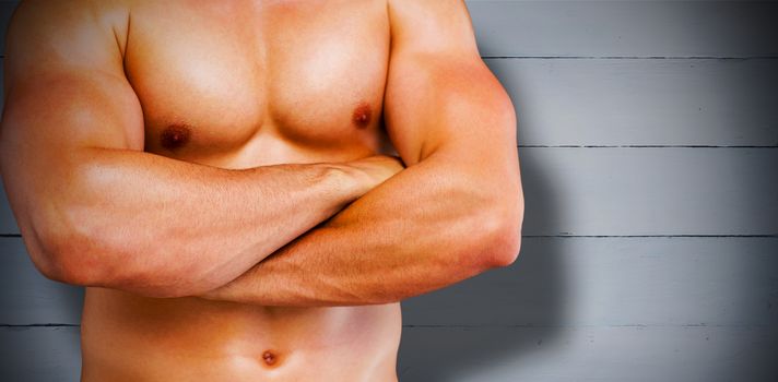 Bodybuilder  against painted blue wooden planks