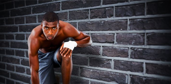 Fit muscular man against red brick wall
