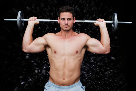 Bodybuilder lifting barbell against black background