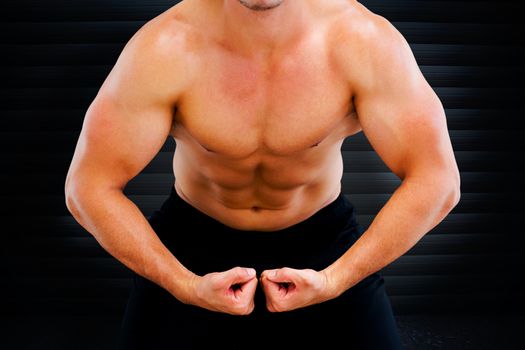 Bodybuilder flexing against black background