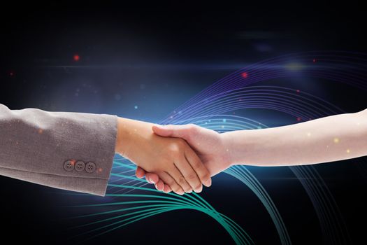 Handshake between two women against futuristic glowing lines on black background