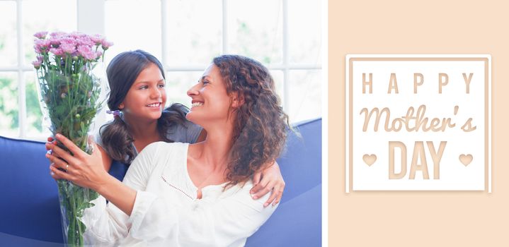 mothers day greeting against happy mother and daughter sitting on the couch with flowers