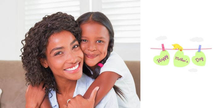 mothers day greeting against pretty mother sitting on the couch with her daughter smiling at camera