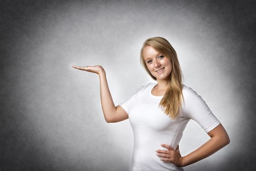 Blond woman presenting something, free space