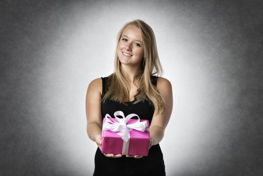 Blond smiling woman holding a present