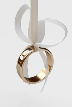Gold wedding ring with bow on white background