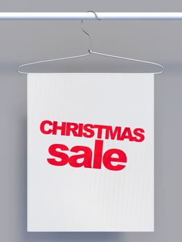 Wire hanger on clothes rail and banner with sale sign