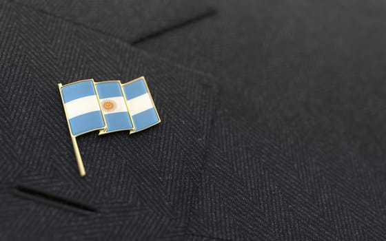 Argrntina flag lapel pin on the collar of a business suit jacket shows patriotism