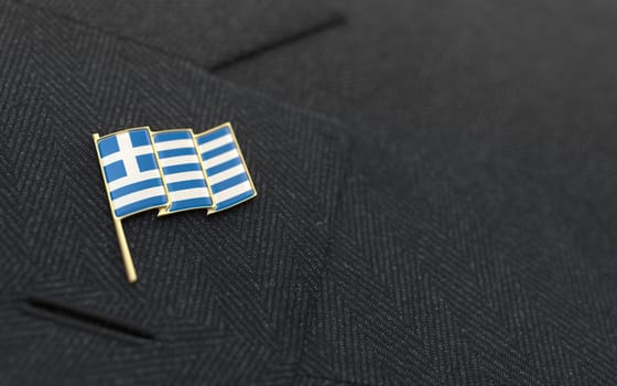 Greece flag lapel pin on the collar of a business suit jacket shows patriotism