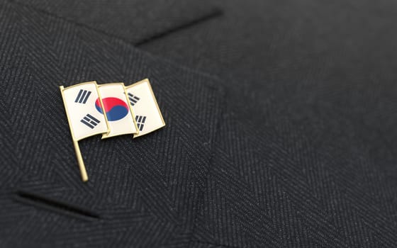 South Korea flag lapel pin on the collar of a business suit jacket shows patriotism
