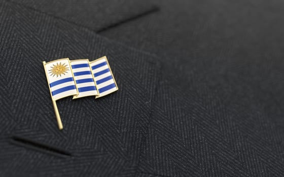 Uruguay flag lapel pin on the collar of a business suit jacket shows patriotism