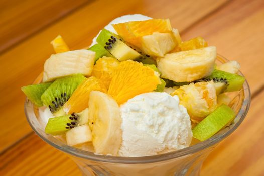 Orange, banana and kiwi fruit salad with icecream