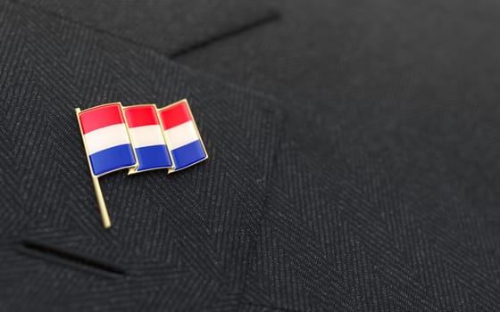 Netherlands flag lapel pin on the collar of a business suit jacket shows patriotism