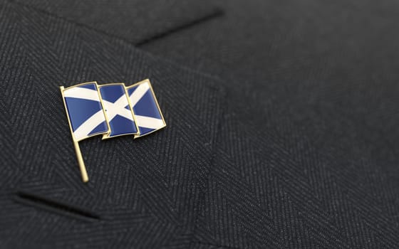 Scotland flag lapel pin on the collar of a business suit jacket shows patriotism