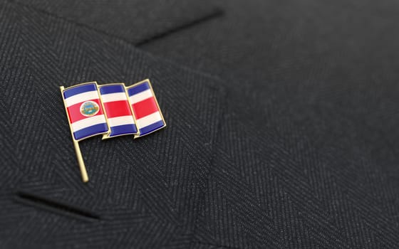 Costa Rica flag lapel pin on the collar of a business suit jacket shows patriotism