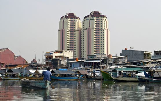 Old canal full of boats in Jakarta harbor, Indonesia