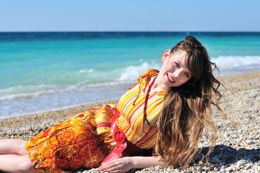 summer beautiful girl laying near the sea 
