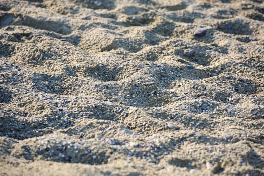 beach sand relief at sunset, selective focus, suitable as background 