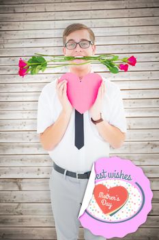 Geeky hipster holding red roses and heart card against wooden planks background