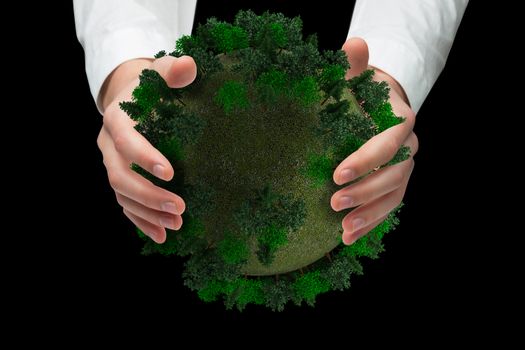 Hands holding against sphere covered with forest