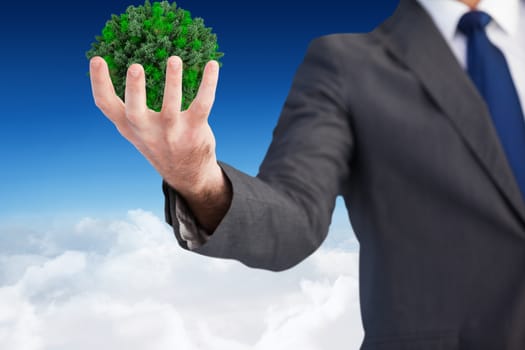 Businessman presenting with his hands against blue sky over clouds