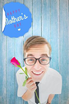 Geeky hipster holding a red rose against wooden planks