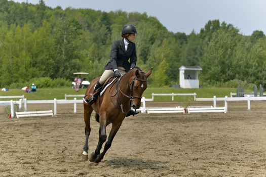 A horsewoman of obstacle in preparation for competition