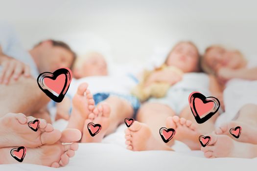 Close up of the feet of a family against red hearts