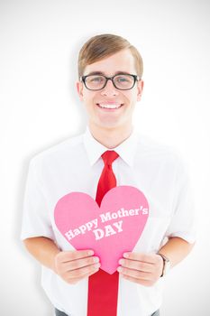 Geeky hipster holding heart card against mothers day greeting