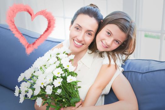 cloud heart against mother and daughter smiling at camera