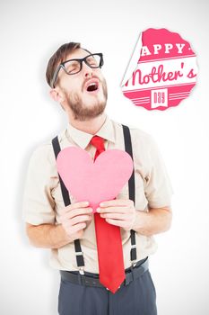 Geeky hipster crying and holding heart card against mothers day greeting