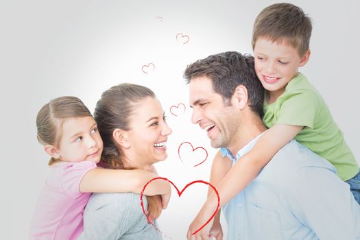 Cheerful young family posing against heart