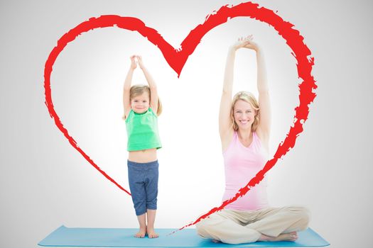 Pregnant mother and daughter doing yoga together against heart
