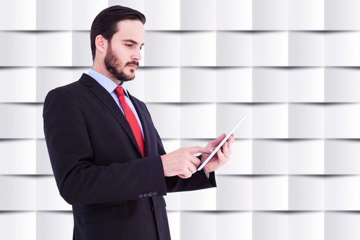 Businessman scrolling on his digital tablet against abstract background