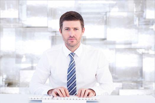 Businessman working at his desk against abstract background