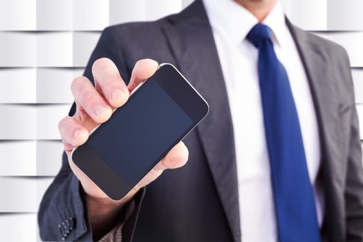 Businessman showing his smartphone screen against abstract background