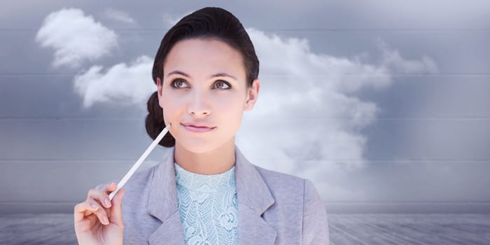 Happy brunette against clouds in a room