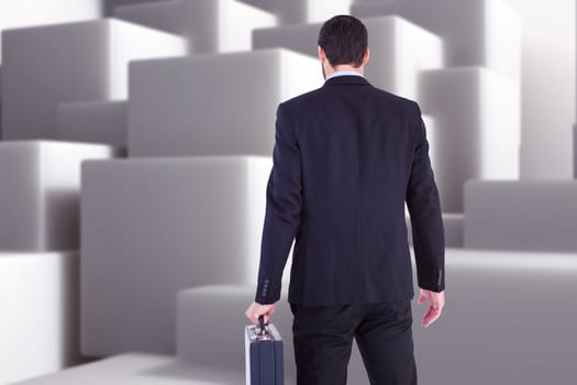 Rear view of businessman holding a briefcase against abstract white design