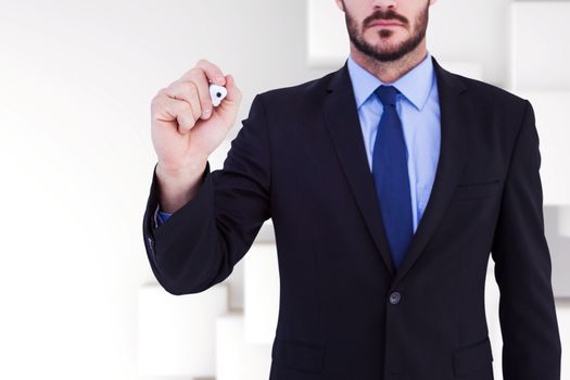 Focused businessman writing with marker against abstract white design